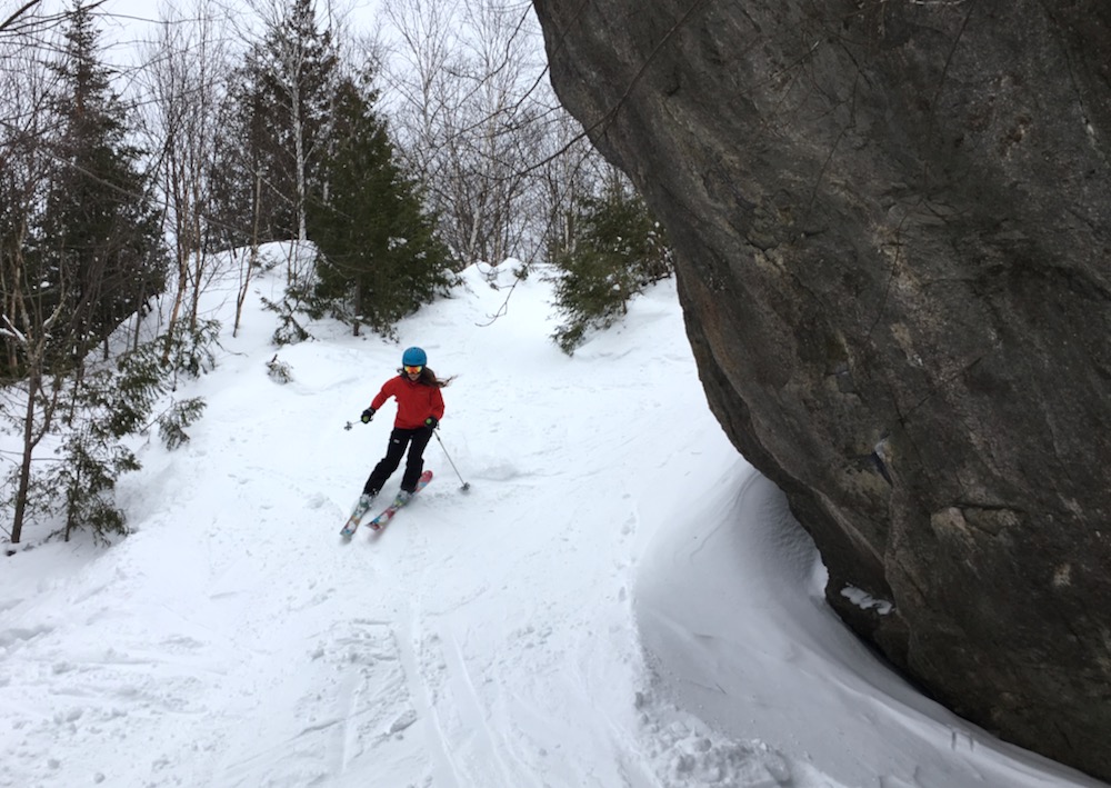 skiing around a boulder